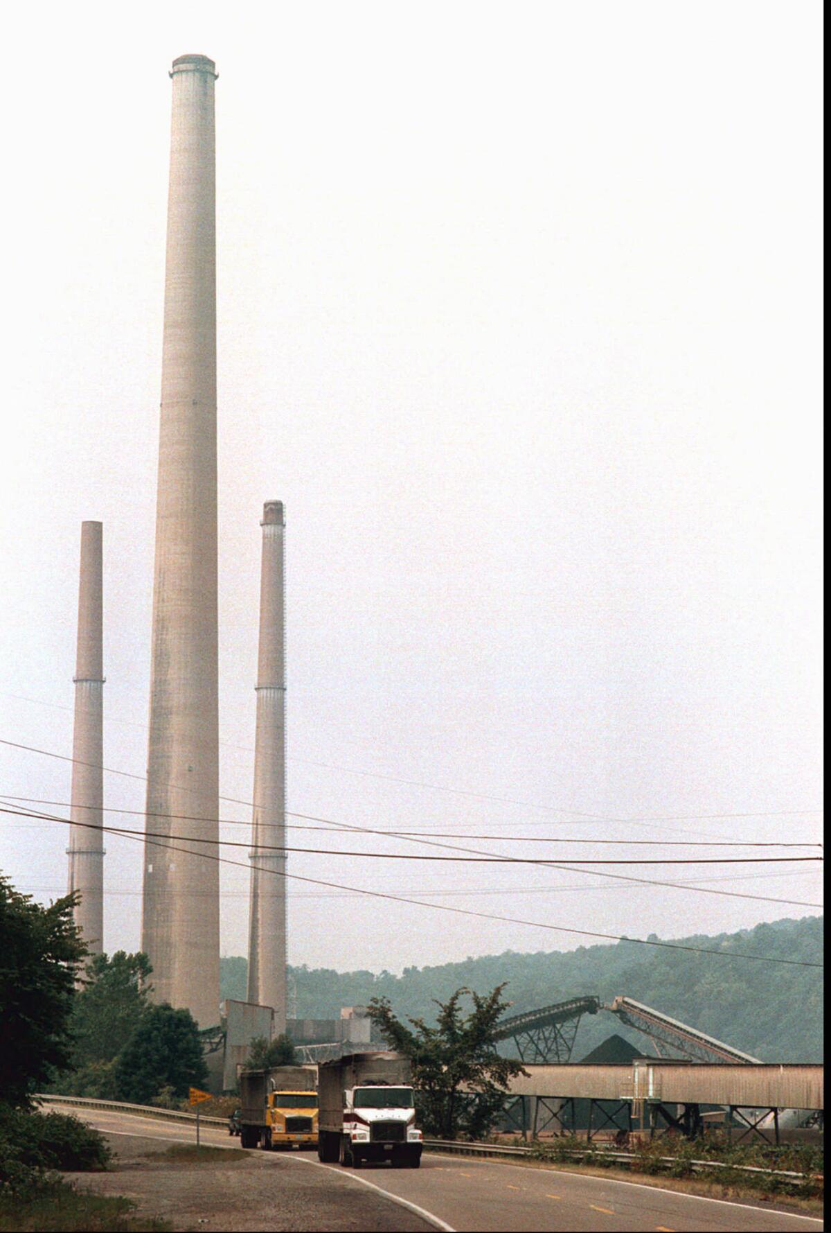 A file photo shows a 1,200-foot-high smoke stack at a coal-burning power plant in West Virginia.
