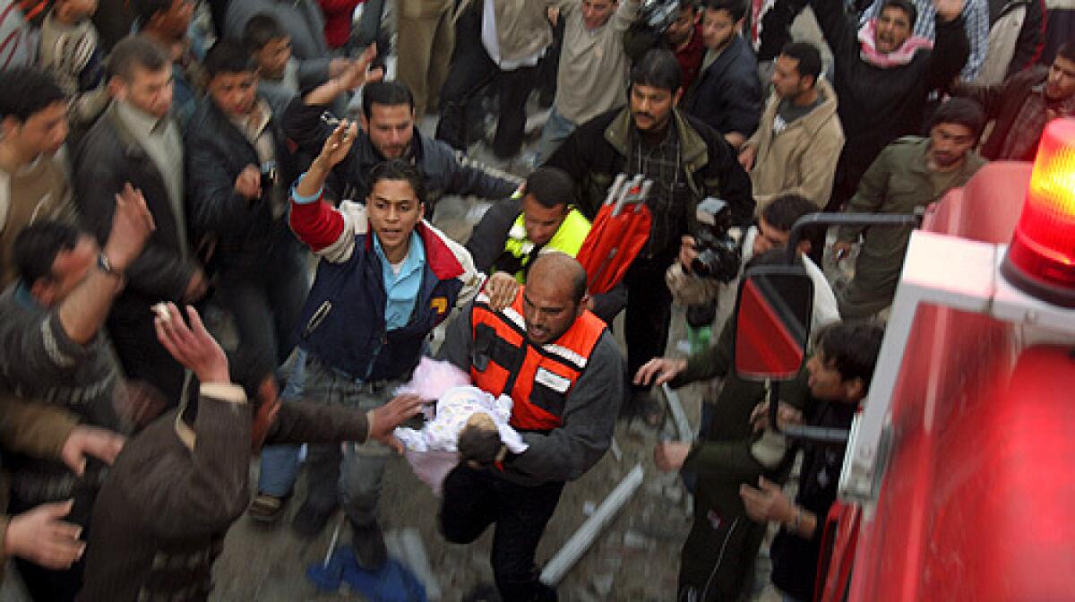 A Palestinian medic evacuates an injured child after an Israeli missile strike in Gaza City on Saturday.