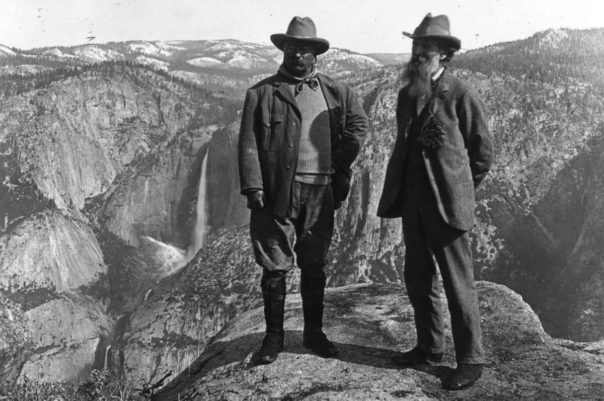 Theodore Roosevelt stands with conservationist John Muir on Glacier Point in Yosemite