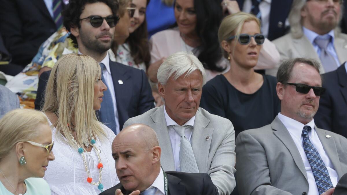 Former Wimbledon champion Bjorn Borg, center, sits in the royal box before the men's singles semifinal match between John Isner and Kevin Anderson.