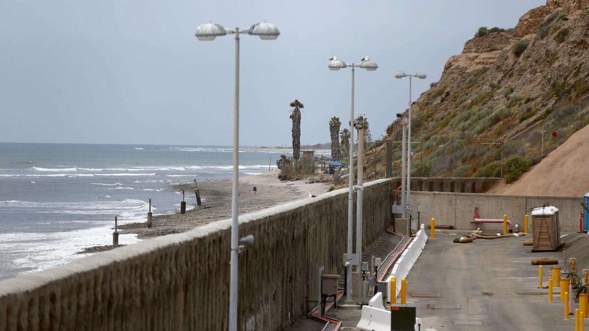 A view of the 28-foot sea wall with San Onofre State Beach in the background at the decommissioned San Onofre Nuclear Generating Station in San Clemente.