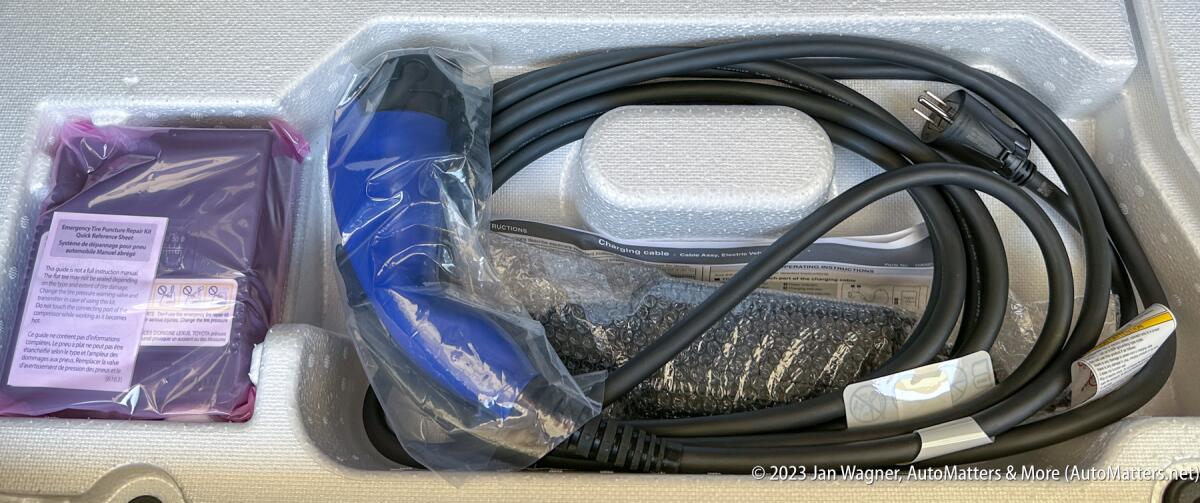 120-volt charging cable stored under the rear deck