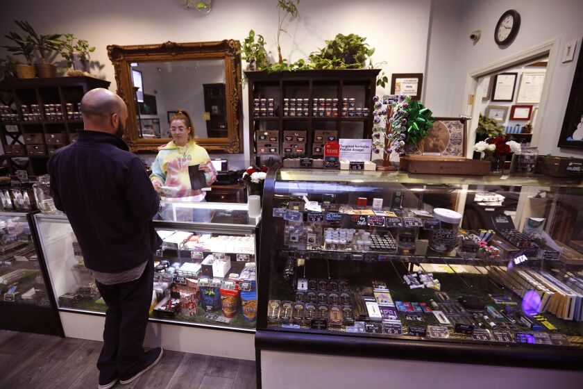 SHERMAN OAKS, CA - DECEMBER 28, 2017 -- Budtender Erin Clowry fills an order for a customer at The Higher Path marijuana dispensary in Sherman Oaks on December 28, 2017. Jerred Kiloh, owner of The Higher Path, has been operating in line with previous city rules. Kiloh plans to shut down in January because Los Angeles has not yet issued city licenses for pot shops. Although the city has granted medical marijuana dispensaries like his "limited immunity" from city prosecution while they seek licenses, Kiloh said he doesn't want to be in violation of state law, which requires any "commercial" cannabis shops to have both state and local licenses to operate in January. (Genaro Molina / Los Angeles Times)