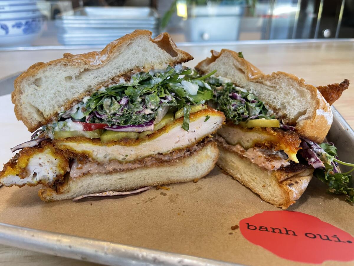 Banh Oui's fried chicken sandwich features kale slaw, garlic sauce and more.