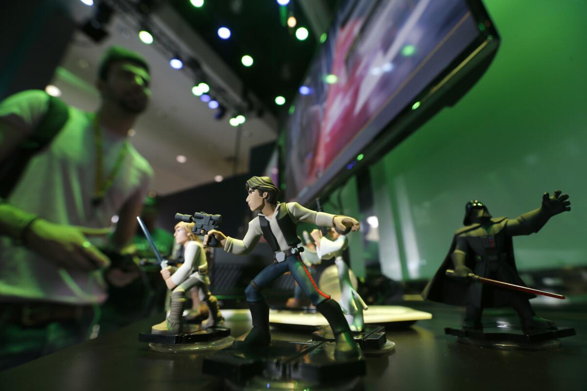 At E3 in downtown Los Angeles, Aryel Abrahami plays "Disney Infinity 3.0," which will add "Star Wars" characters to the series.