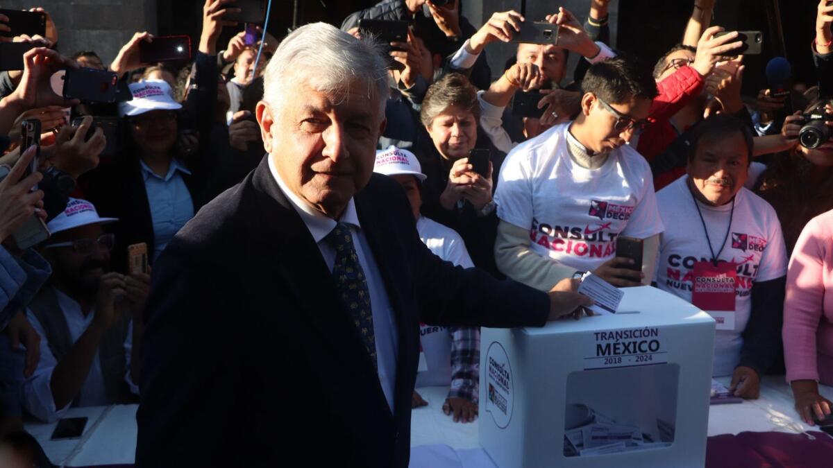 Mexico's president-elect, Andres Manuel Lopez Obrador, casts a vote to decide whether construction of a new airport in Mexico City should continue.