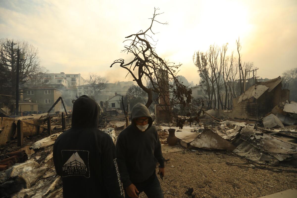 Two people in charred surroundings