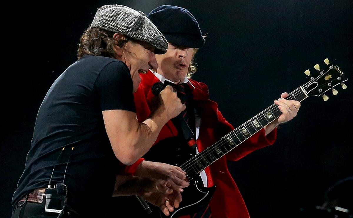 Singer Brian Johnson and guitarist Angus Young of AC/DC perform at the Coachella Valley Music and Arts Festival. The band is allowing their catalog on streaming music services for the first time.