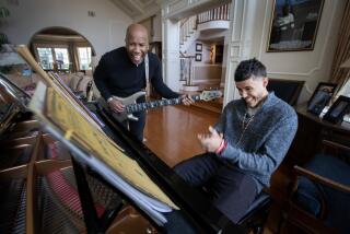 TARZANA, CA - FEBRUARY 16: Bassist Nathan East, left, is making an album with his son, singer-keyboardist Noah East, right. Photographed in their home on Thursday, Feb. 16, 2023 in Tarzana, CA. (Brian van der Brug / Los Angeles Times)