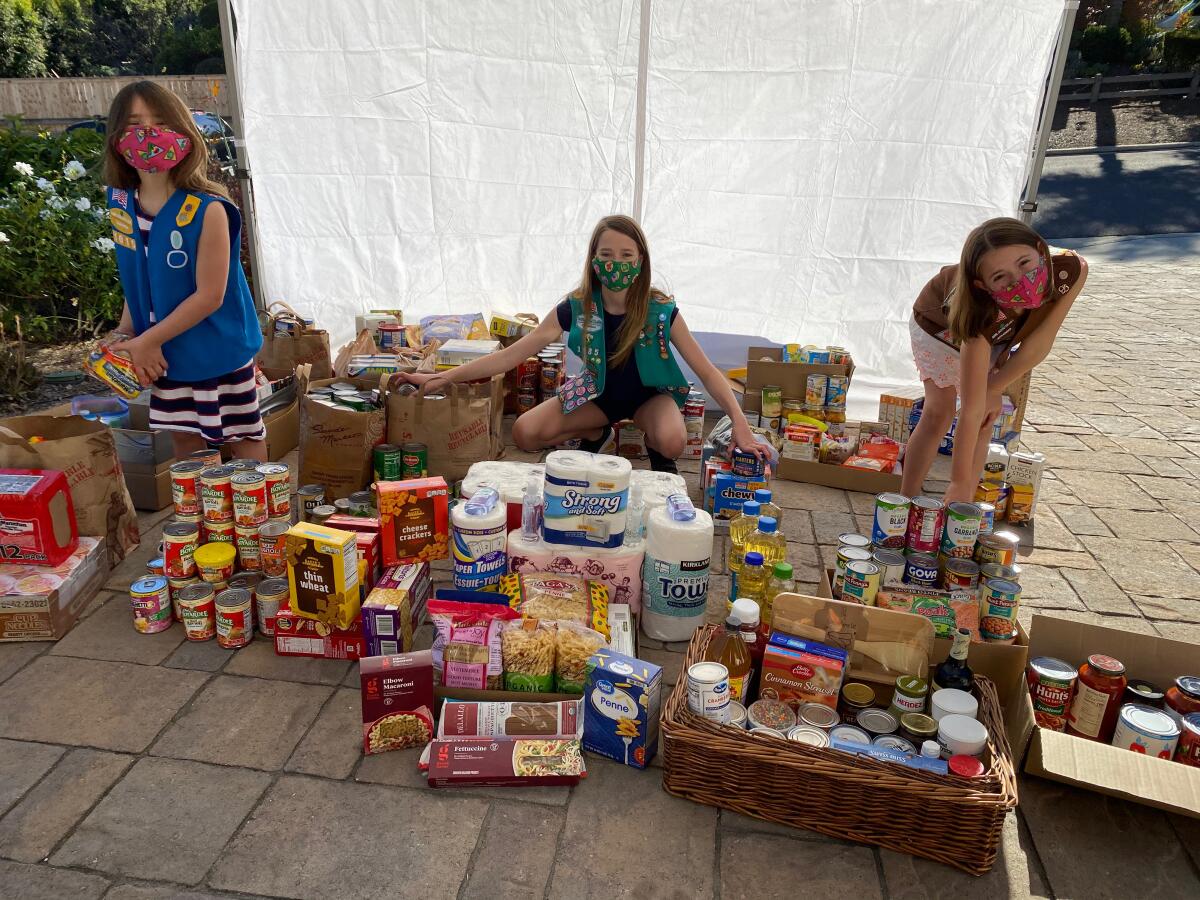 Troop leader Kristen Wade-Kempiak’s daughters work to help others.