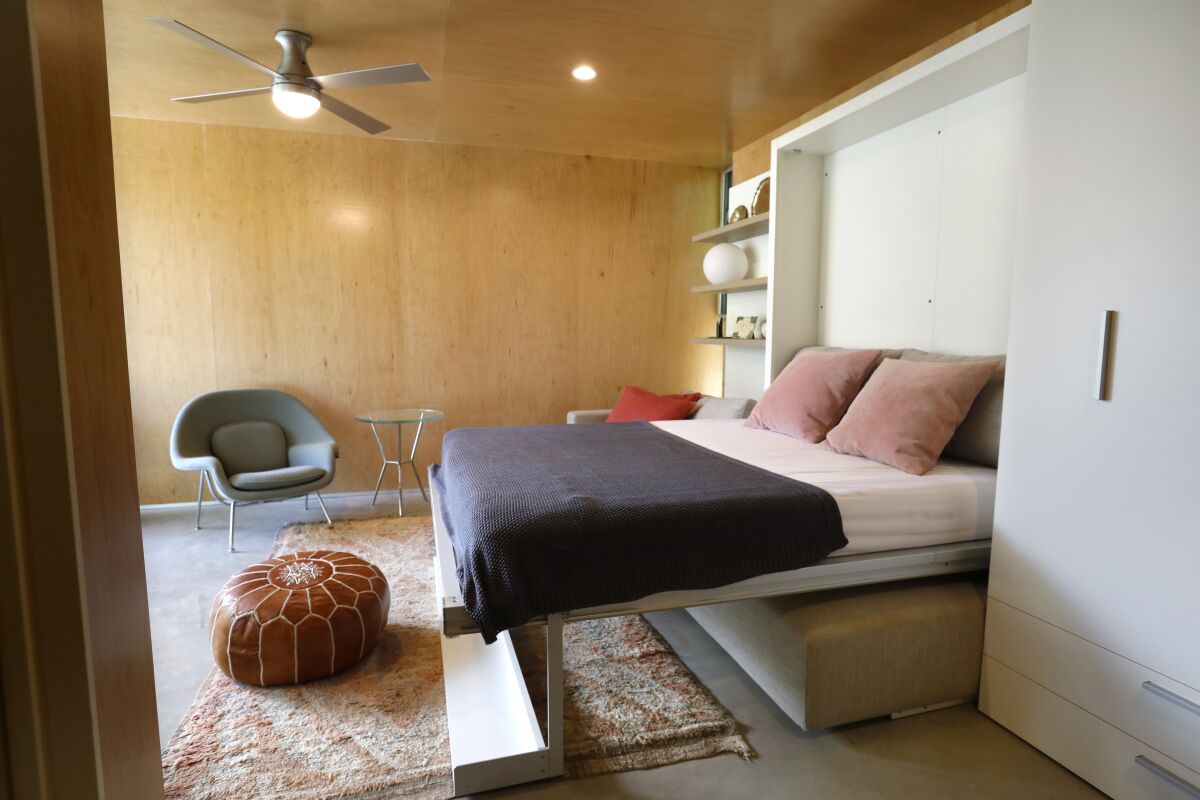 A Murphy bed pulls out over a couch.