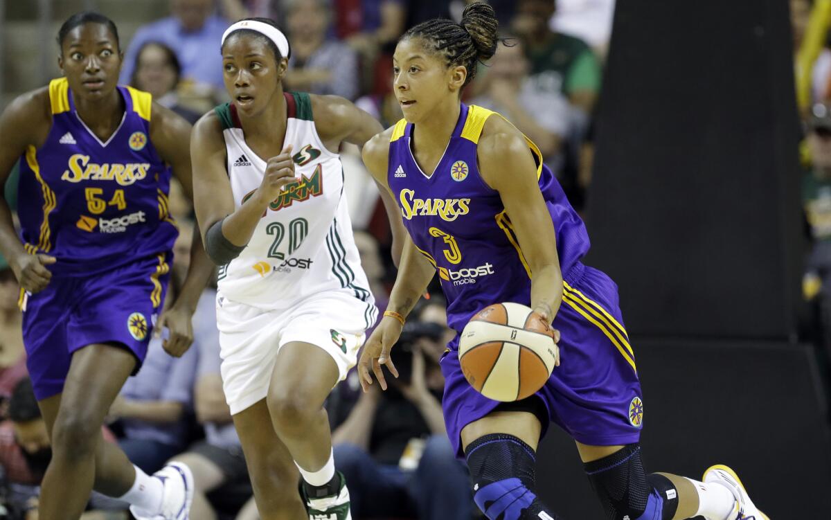 Candace Parker, right, and the Sparks defeated Seattle, 80-69, in their season opener Friday night.
