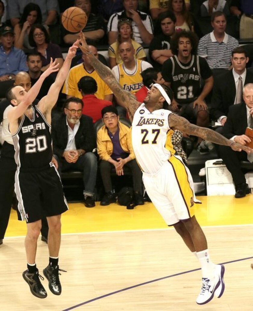 Lakers center Jordan Hill blocks a shot by Spurs guard Manu Ginobili in a playoff game in April. Hill could be left on the outside if the Lakers try to get under the luxury tax salary threshold for the upcoming season.