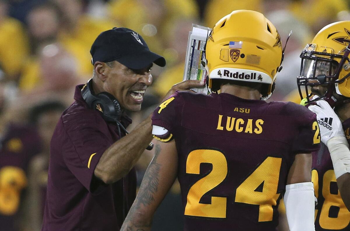 Arizona State coach Herm Edwards congratulates defensive back Chase Lucas (24) after he made a play against Texas San Antonio on Sept. 1.