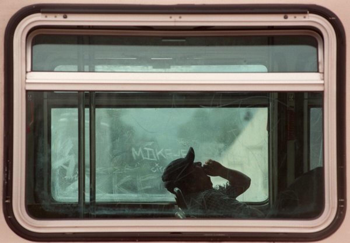 A commuter yawns while his MTA bus makes a stop at a red light along Ventura Boulevard in Sherman Oaks.