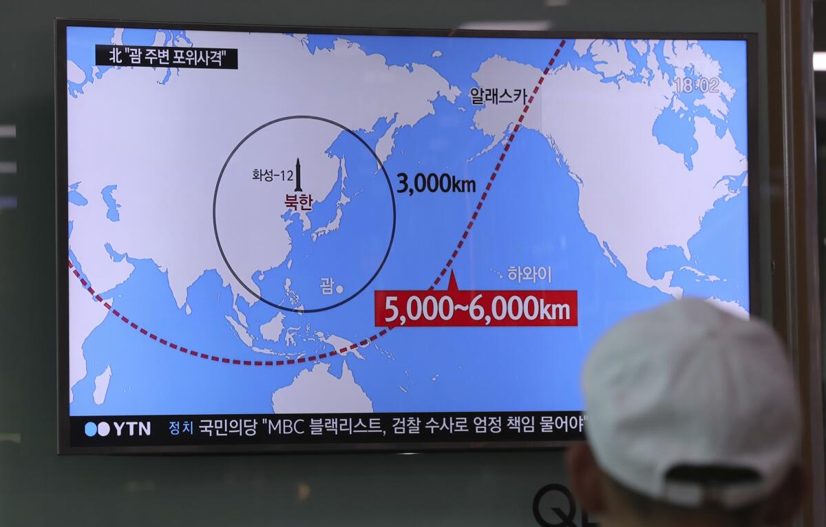 A man at the Seoul train station watches a local news program reporting on North Korea's missiles.