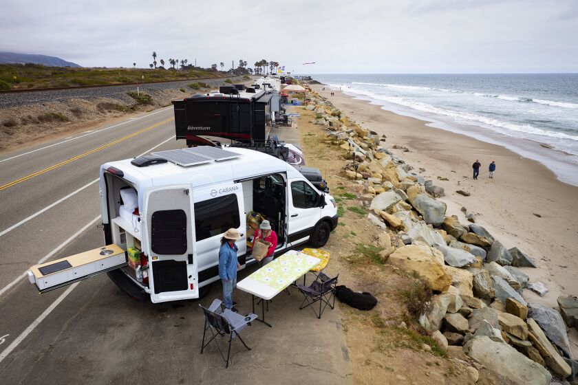 Couple Jeri Palumbo and Erik Zoblerand with their dog Monty set up camp at Rincon Parkway Campground in Ventura in a Cabana van. Photograph by Daniel A. Anderson