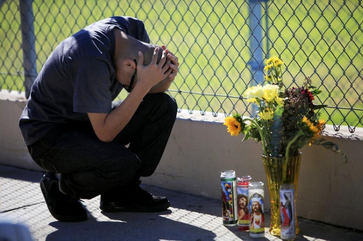Fernando Mora, 25, grieves at a makeshift memorial for his friend Francisco "Frankie" Garcia, a 22-year-old Army veteran who was shot and killed Sunday morning after a dispute in Sylmar.