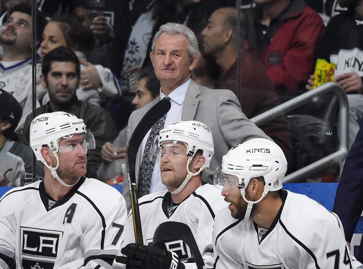 Kings Coach Darryl Sutter stands behind his bench during a game against Anaheim on Feb. 4.