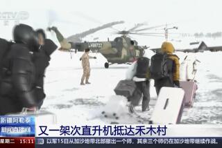 In this image taken from video footage run by China's CCTV, tourists are evacuated by a military helicopter from Altay Prefecture in northwestern China's Xinjiang Uyghur Autonomous Region on Tuesday, Jan. 16, 2024. Chinese state media says that rescuers are evacuating tourists from a remote skiing area in the country's northwest where dozens of avalanches triggered by heavy snow have trapped more than 1,000 people for a week. (CCTV via AP)
