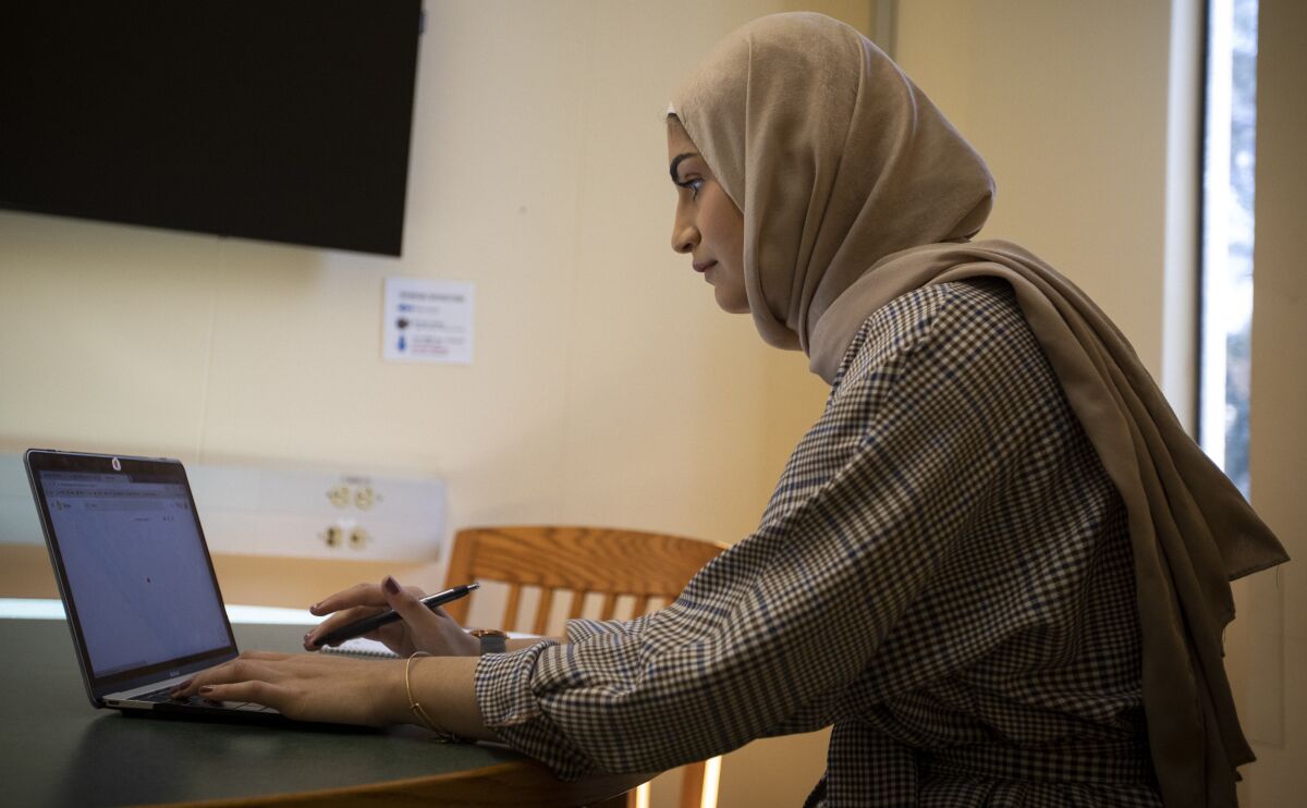 During finals week, third-year student Samia Alkam, 19, prepares at the Tomás Rivera Library for a class presentation.