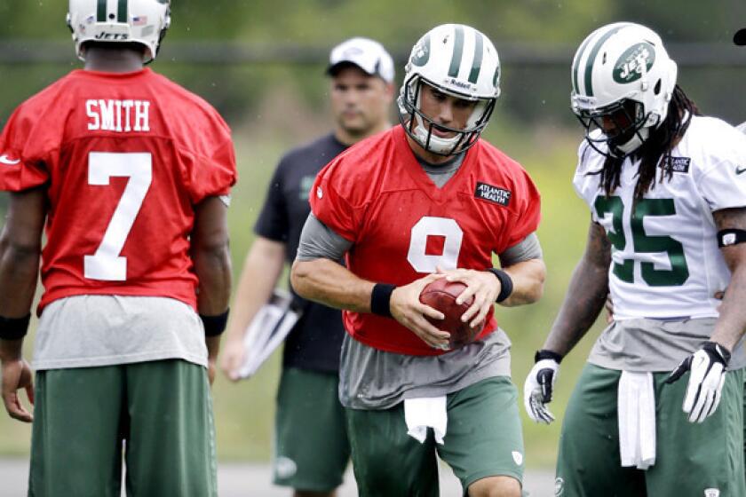 Quarterback Brady Quinn (9) joined rookie Geno Smith and recently acquired running back Alex Green (25) at the Jets' practice on Monday.