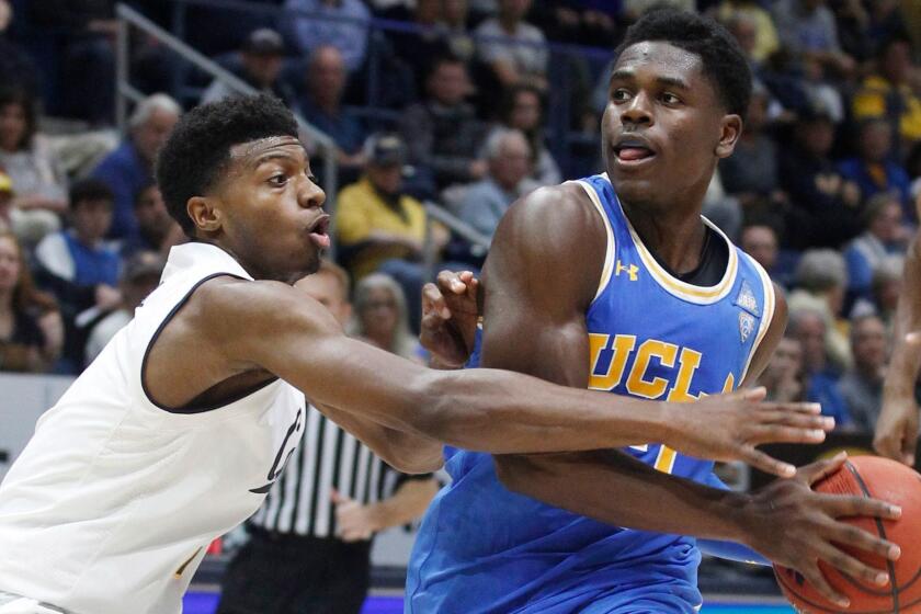 UCLA's Aaron Holiday drives for the basket as California's Darius McNeill defends during the second half of an NCAA college basketball gamep Saturday, Jan. 6, 2018, in Berkeley, Calif. UCLA beat California 107-84. (AP Photo/George Nikitin)