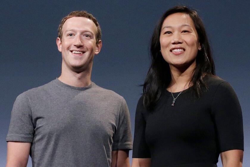 FILE- In this Sept. 20, 2016, file photo, Facebook CEO Mark Zuckerberg and his wife, Priscilla Chan, smile as they prepare for a speech in San Francisco. Liam Booth, the security chief of Zuckerberg and his family, has been accused of sexual misconduct and making racist and homophobic comments about members of his staff and about Zuckerberg’s wife, Chan. (AP Photo/Jeff Chiu, File)