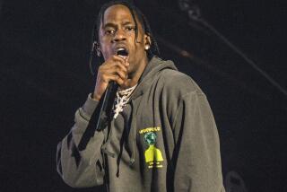 FILE - This March 3, 2018 file photo shows Travis Scott performing at the Okeechobee Music and Arts Festival on Saturday, March 3, 2018, in Okeechobee, Fla. Scott and Cardi B are heading to the City of Brotherly Love to headline Jay-Z’s annual Made in America festival in Philadelphia over Labor Day weekend. (Photo by Amy Harris/Invision/AP)