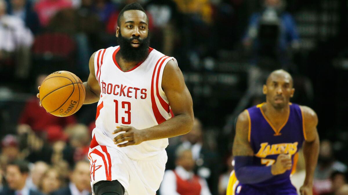 Houston Rockets guard James Harden, left, dribbles the ball ahead of Lakers guard Kobe Bryant.