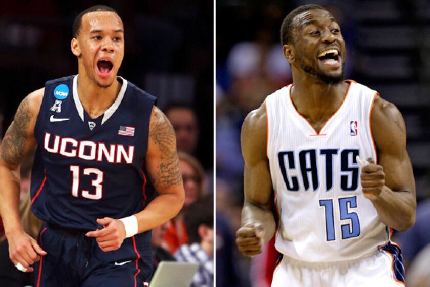 Connecticut point guard Shabazz Napier (13) is following in the footsteps of mentor Kemba Walker, a former UConn star and starter with the Charlotte Bobcats in the NBA.