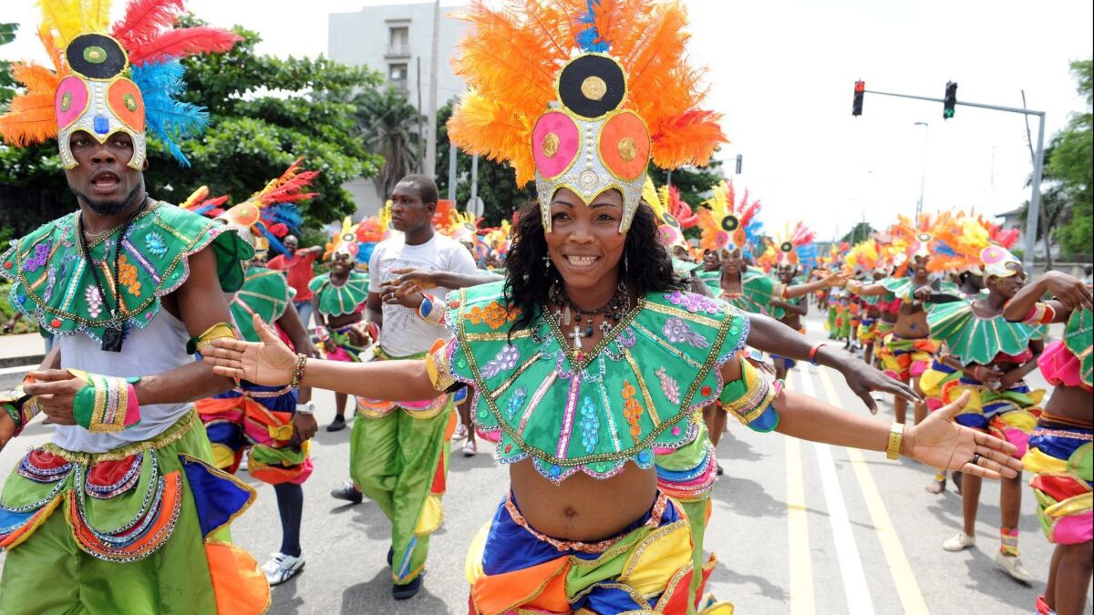 People dance in a procession during the yearly carnival in Lagos, Nigeria on April 9, 2012.