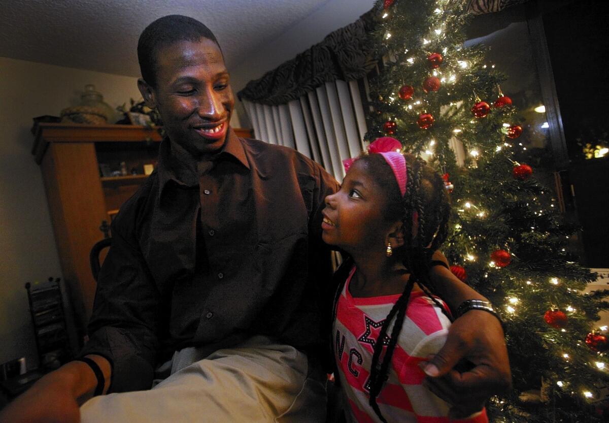 DeAndre Howard spends his first evening as a free man with his niece Briana Brown, 7, and other friends and family at his aunt Valdine Brown's home in Torrance.