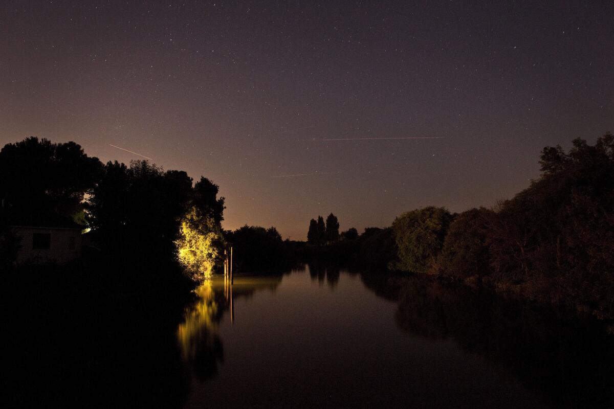 Stars and airplanes leave trails in the night sky over the Sacramento-San Joaquin Delta.