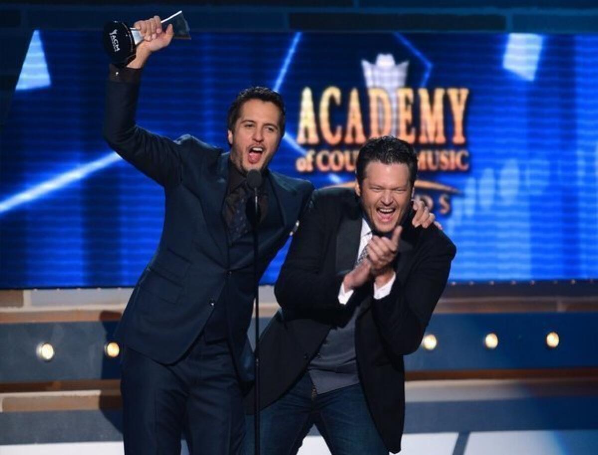 Co-hosts and recording artists Luke Bryan, left, and Blake Shelton speak onstage after Bryan accepted the Entertainer of the Year award during the 48th Annual Academy of Country Music Awards at the MGM Grand Garden Arena on Sunday in Las Vegas.