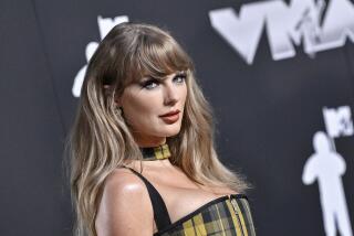 Taylor Swift smiles with her hair down in a yellow tartan bustier