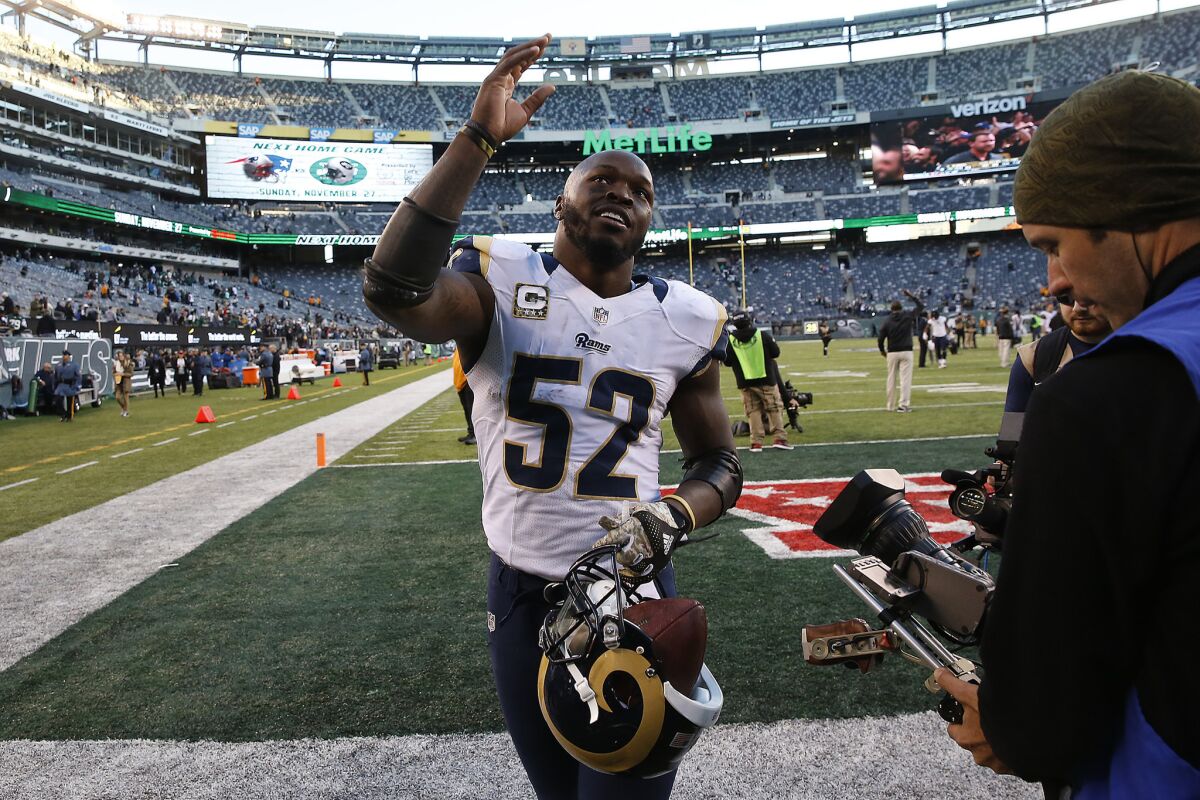 With the game ball in his helmet, Rams linebacker Alec Ogletree waves to fans as he heads to the locker room after sealing a 9-6 win over the New York Jets with an interception on Nov. 13.
