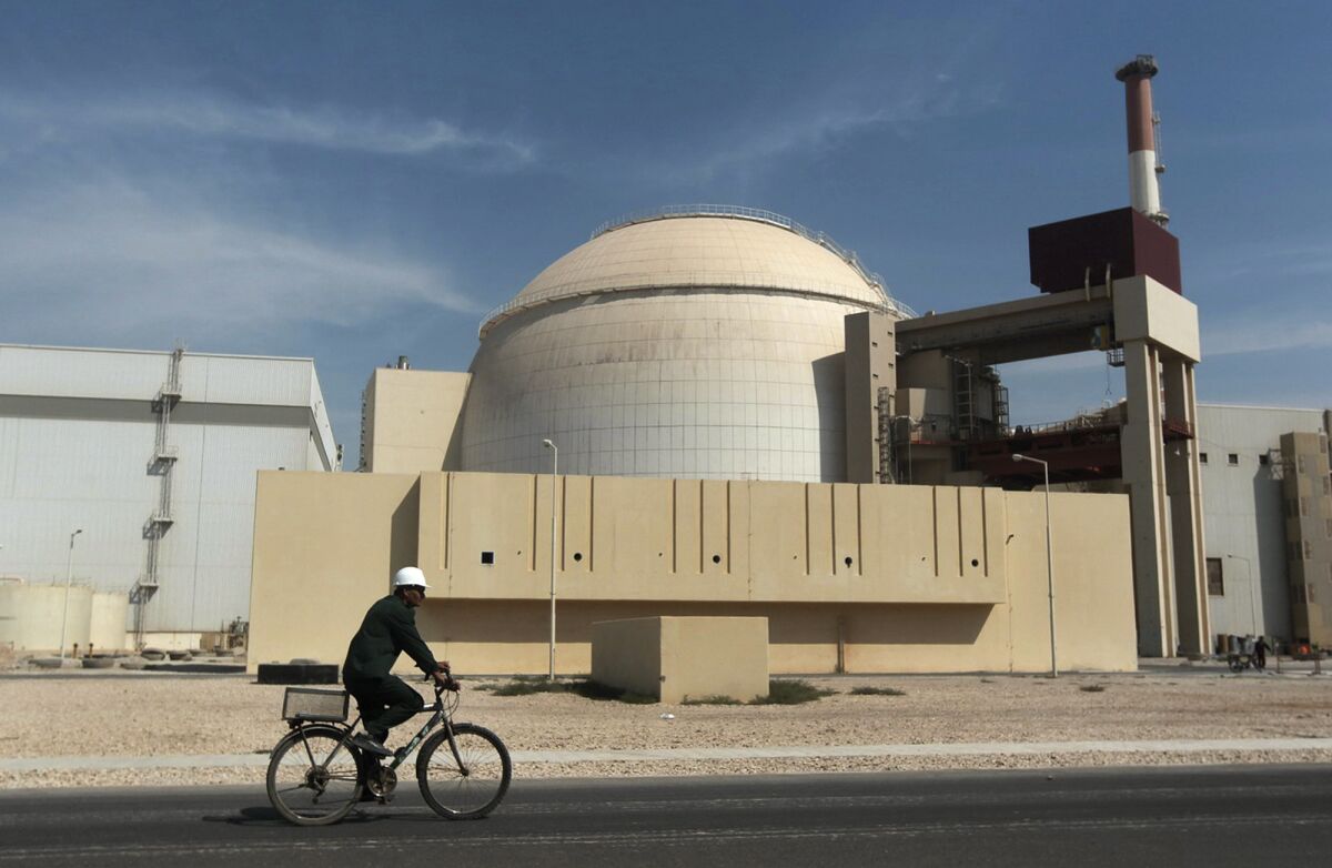 A worker makes his way in front of the reactor building at the Bushehr nuclear power plant in Iran.