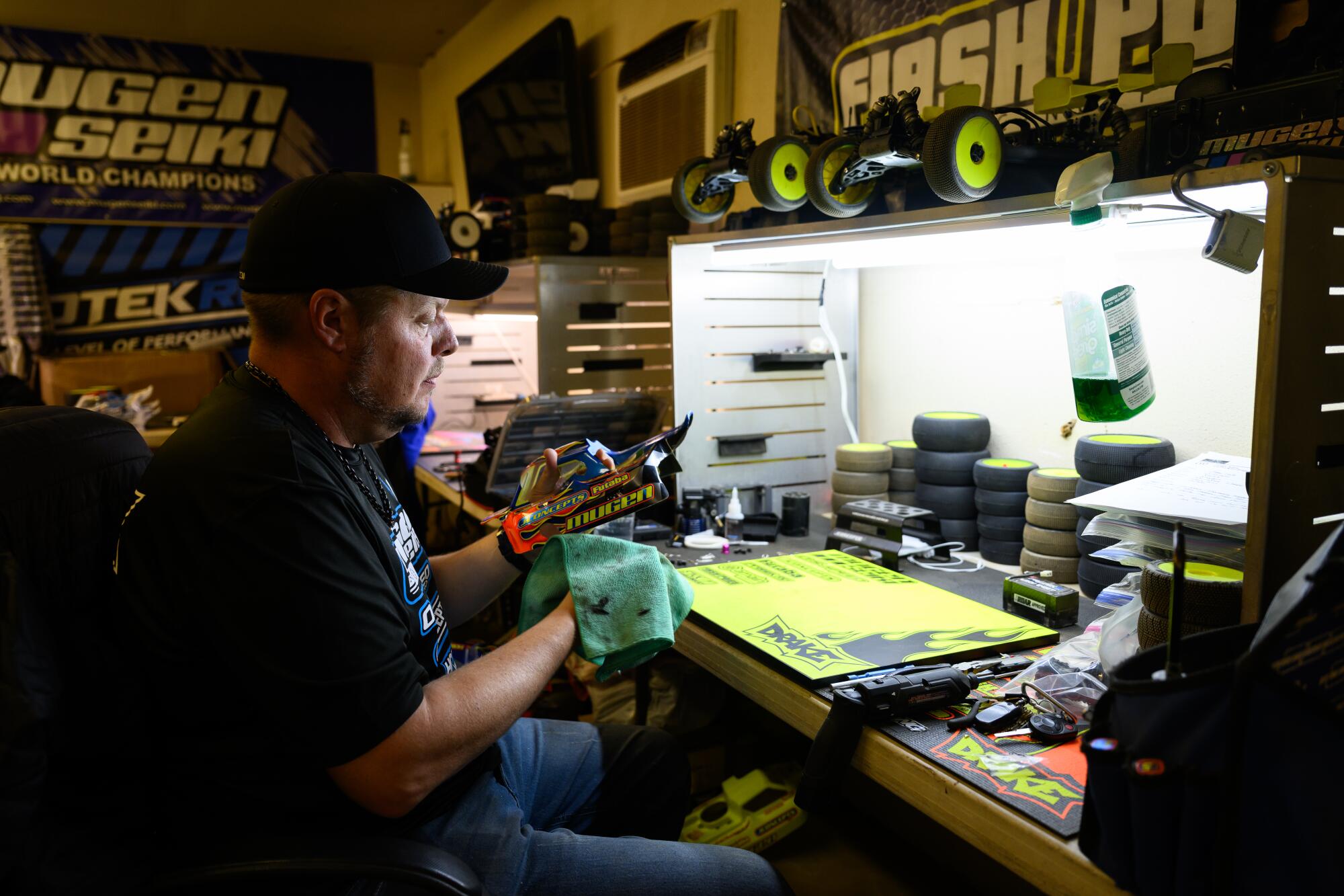 Adam Drake cleans the body of his RC car