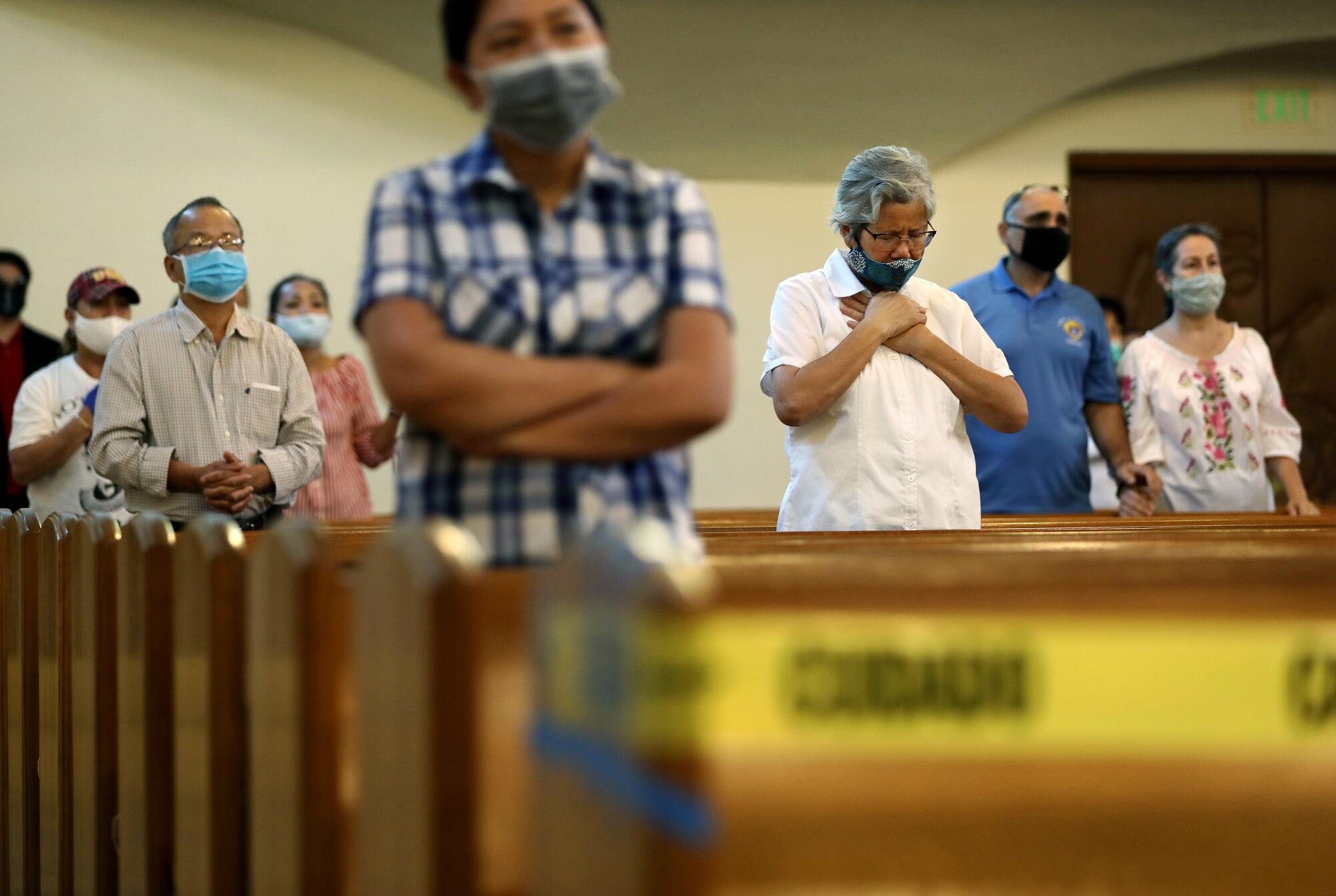 Parishioners attend mass at San Gabriel Mission Church in San Gabriel.