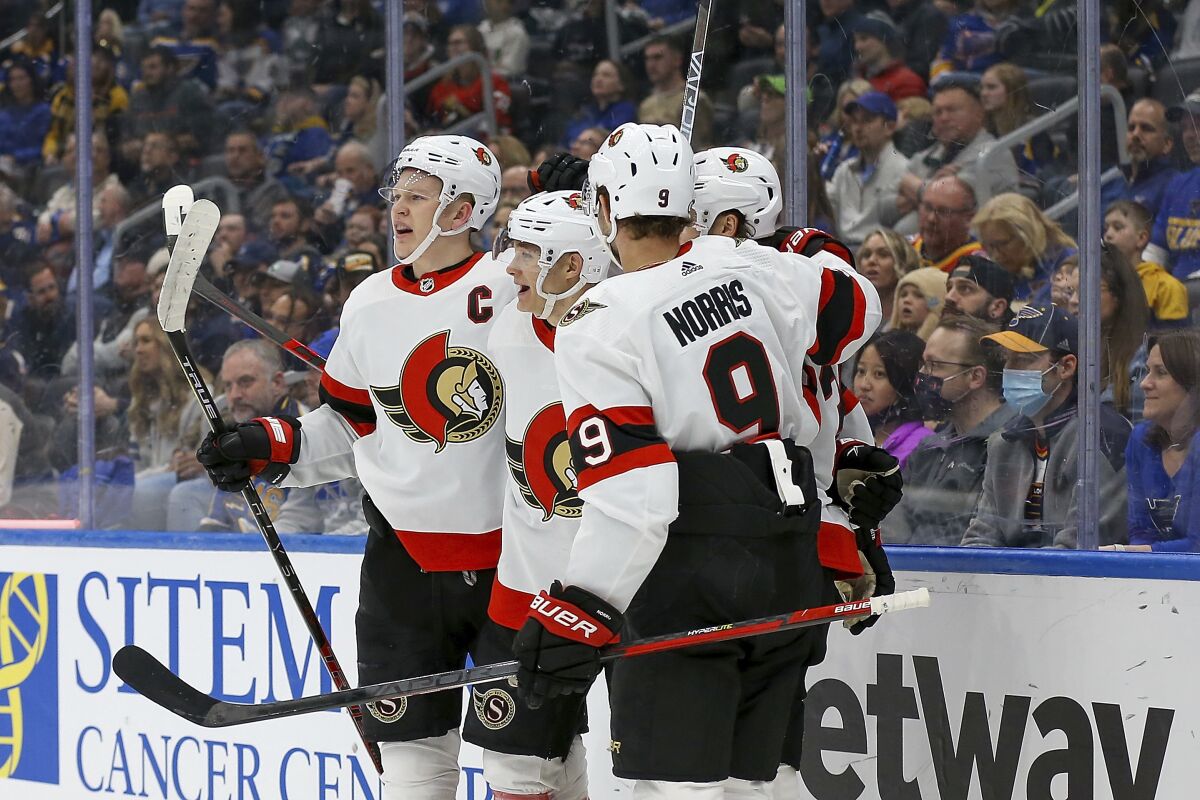 Members of the Ottawa Senators celebrate after scoring a goal during the first period of an NHL hockey game against the St. Louis Blues Tuesday, March 8, 2022, in St. Louis. (AP Photo/Scott Kane)