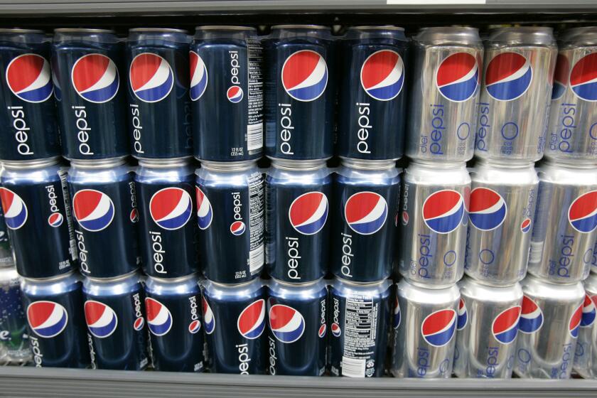 Pepsi cola drinks are displayed at a convenience market. Diet Pepsi, at right, in the silver cans, will shift from using aspartame to a less controversial artificial sweetener, sucralose.