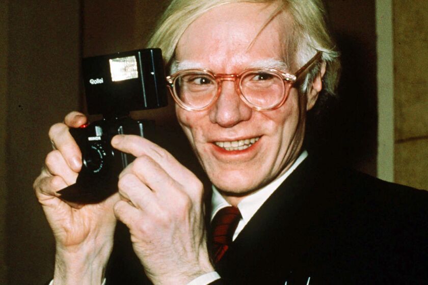 FILE - In this 1976 file photo, pop artist Andy Warhol smiles in New York. A federal appeals court sided with a photographer Friday, March 26, 2021, in her copyright dispute over how a foundation has marketed a series of Andy Warhol works of art based on her pictures of Prince. (AP Photo/Richard Drew, File)
