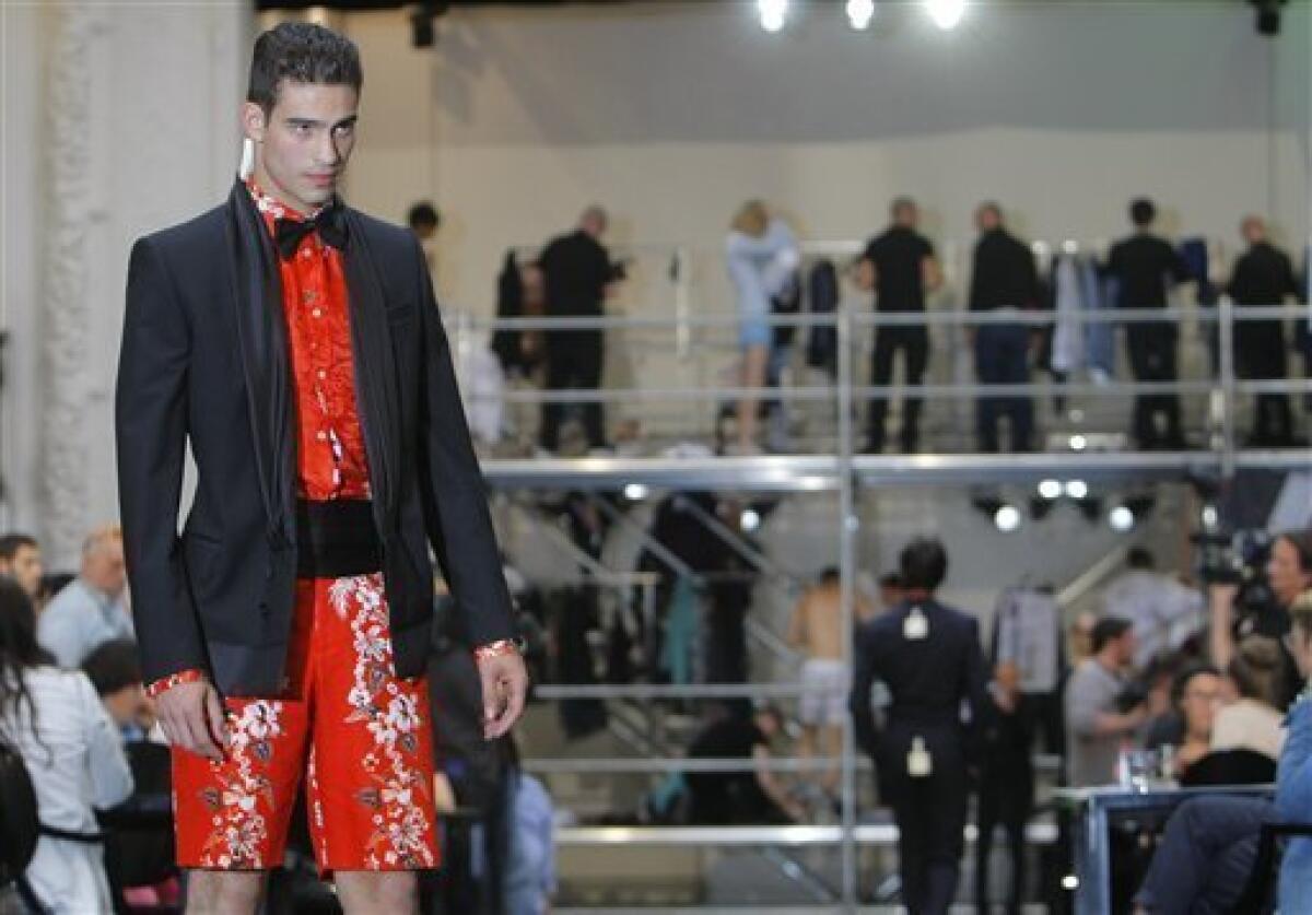 A model displays a bag by British-born designer Kim Jones and U.S designer  Marc Jacobs as part of Louis Vuitton's spring-summer 2012 men's fashion,  presented in Paris, Thursday, June 23, 2011. (AP