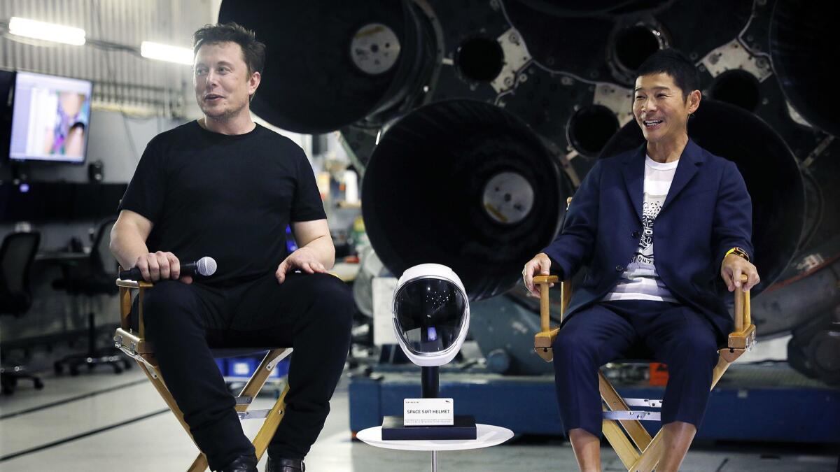 SpaceX CEO Elon Musk, left, announces the first private passenger who will fly around the moon aboard BFR in 2023: Japanese entrepreneur Yusaku Maezawa, right.