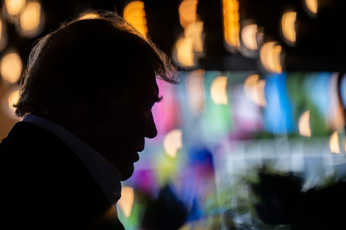 A man in silhouette against colored ligths 