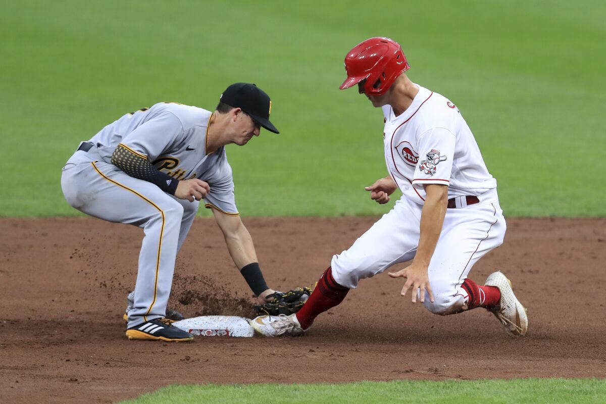 Cincinnati Reds' Josh VanMeter flies into a double play, as Pittsburgh Pirates' Gregory Polanco throws to Kevin Newman, left, causing Cincinnati Reds' Nick Senzel, right, to be out at second base in the second inning during a baseball game at in Cincinnati, Friday, Aug. 14, 2020. (AP Photo/Aaron Doster)