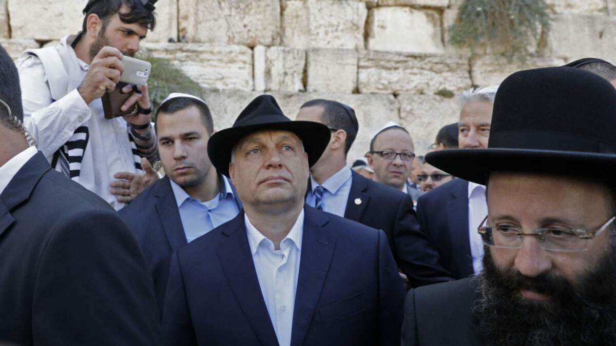 Hungarian Prime Minister Viktor Orban, center, visits the Western Wall in Jerusalem on July 20. Orban pledged "zero tolerance" for anti-Semitism after being accused of stoking anti-Jewish sentiment at home.