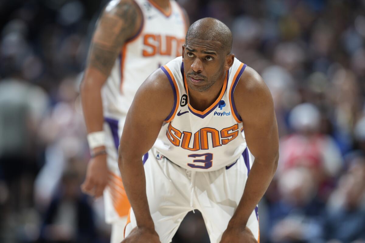 Phoenix Suns guard Chris Paul stands on the court during a playoff game against the Denver Nuggets.