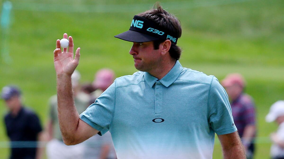 Bubba Watson acknowledges the cheers from the gallery after sinking a putt on the seventh green during the second round of the Travelers Championship at TPC River Highlands in Cromwell, Conn., on Friday.